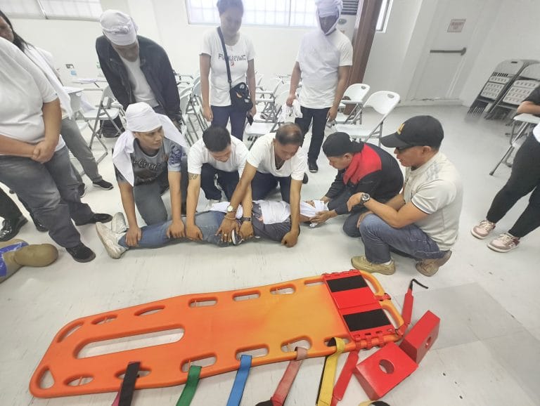 Personnel practicing stretcher handling during first aid training